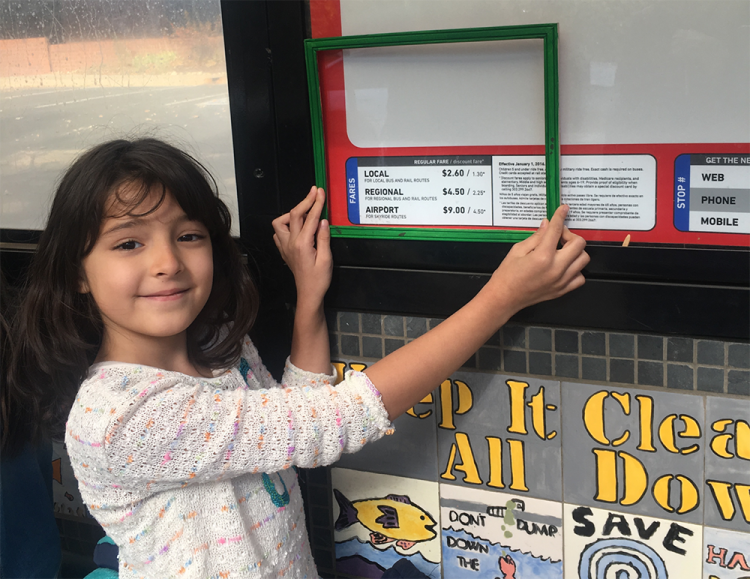 A Whittier Elementary School student uses a green frame to show that she likes the sign being low enough for children to read it. Students used green and red frames to frame the things they liked and didn’t like about the HOP.