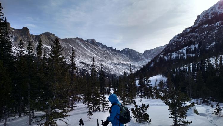 Bright sky and hikers in the snow