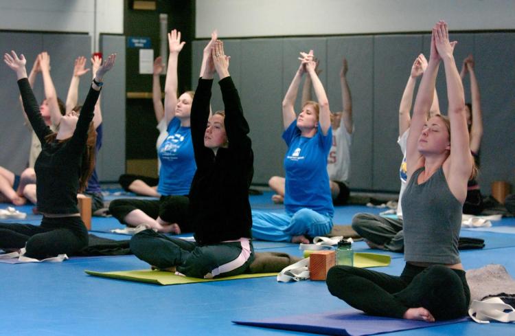 Students partaking in yoga class at The Rec