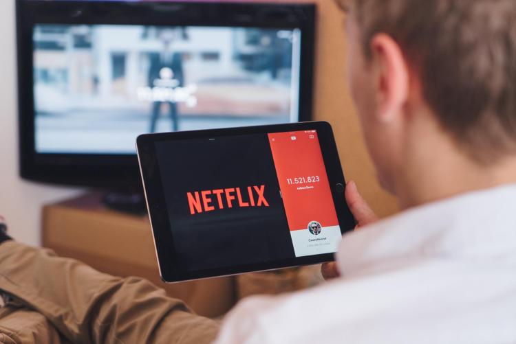 Person watching Netflix on tablet