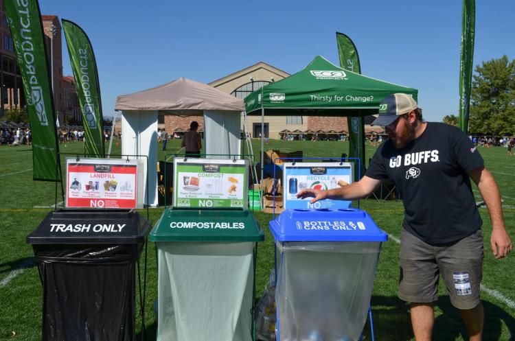 A person recycling a can at CU Boulder
