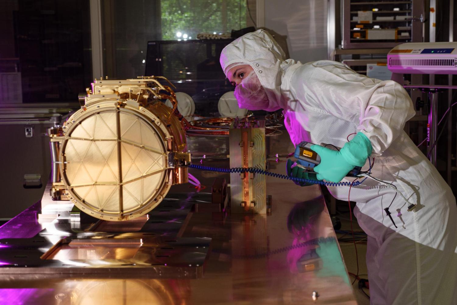 An engineer ground tests Europa Clipper’s dust analyzer. (Credit: NASA/CU Boulder/Glenn Asakawa)