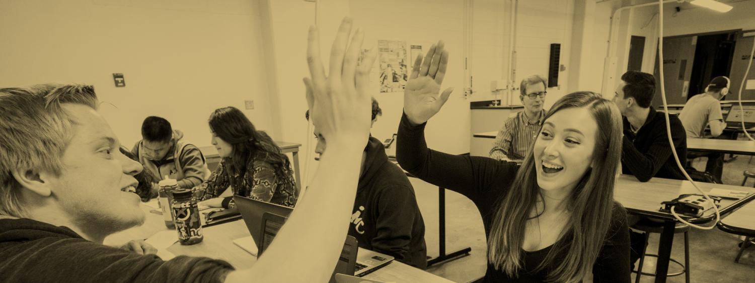 Students give each other a high five.