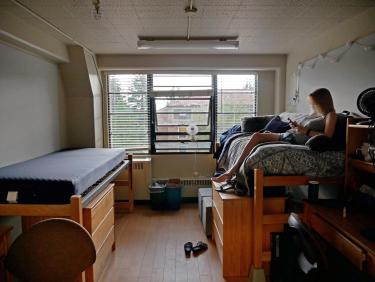 Student spending alone time in dorm room