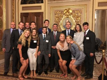 Students pose for a photo in the Senate Chamber