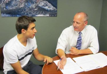 Attorney Bruce Sarbaugh consults a student