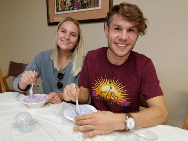 Two Crafternoon participants pose for a picture and display their crafts