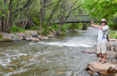 Ryan Watson fishes in Boulder Creek