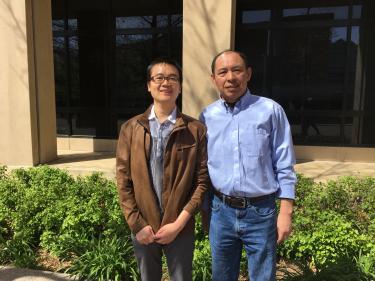 Hongyun Tang and Min Han stand in front of the MCDB building