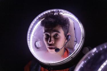 A space helmet, worn by CU Boulder mechanical engineering student Giordan Thompson, glows in the dark desert night. Communicating by radio with over 20 people proved to be quite challenging, the students learned.