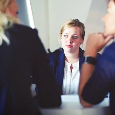 Woman listens to co-workers