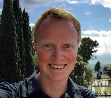 Matthew Hurst stands in front of trees.