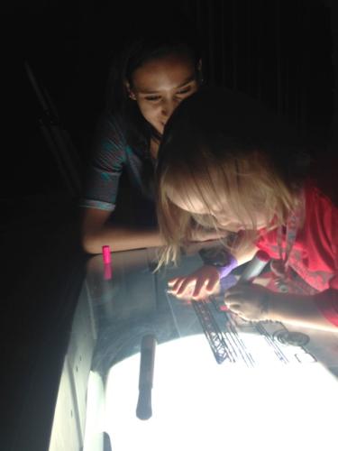 A child plays on a light table at night