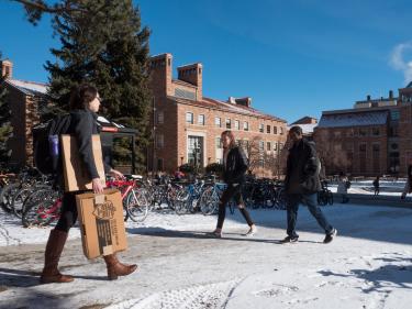 students walking on a snowy campus