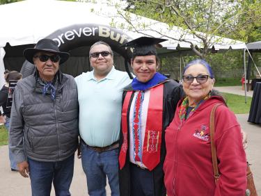 Student with family members at Native Graduation