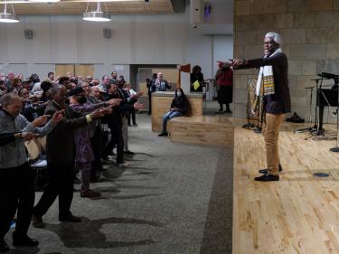 Nii Armah Sowah leads a crowd in dance. (Glenn Asakawa/University of Colorado)