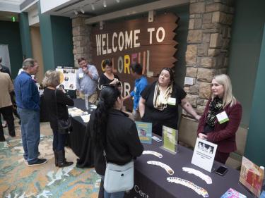 Attendees visit different campus booths at the summit