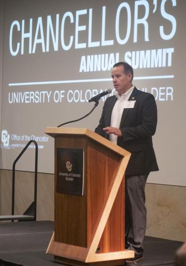 Ryan Chreist, Assistant Vice Chancellor and Executive Director with the CU Alumni Association, addresses the audience during the 2023 Chancellor’s Summit for the University of Colorado Boulder. (Photo by Casey A. Cass/University of Colorado)