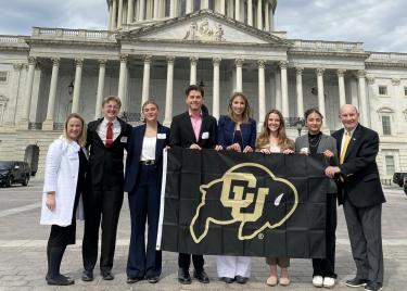 Chancellor, Stefanie Johnson and student leaders in front of the capitol building