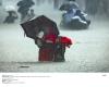 A mother brings her children to safety in floodwater that stranded 6 million.