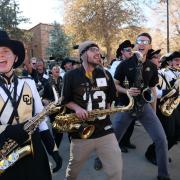 Members and alumni of the CU Marching Band perform during pre-game festivities for Homecoming weekend on the CU Boulder campus on Saturday, Nov. 9, 2019. (Photo by Glenn Asakawa/University of Colorado)