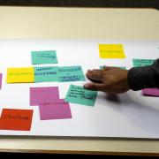Participants work with sticky notes during a Diversity and Inclusion Summit session