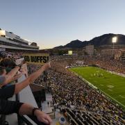 Folsom Field is packed with fans as the sun sets behind the Flatirons.