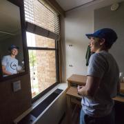 Student looks out window during move-in