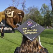 Student graduation cap reading 'The adventure continues'
