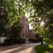 Old Main as seen through tree branches in summer