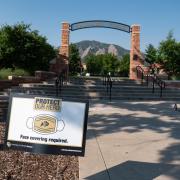 A Protect Our Herd–face covering required sign at the entrance of Farrand Field