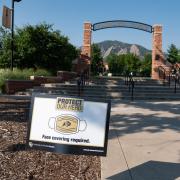 A Protect Our Herd–face covering required sign at the entrance of Farrand Field