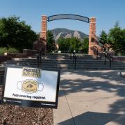 A Protect Our Herd–face covering required sign at the entrance of Farrand Field