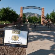 A Protect Our Herd–face covering required sign at the entrance of Farrand Field