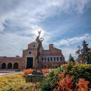 statue outside of the UMC during fall