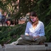 person works on laptop outside