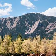 View of the Flatirons from CU Boulder campus in spring.