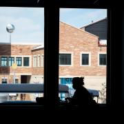 person working on laptop indoors on campus