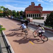 Cyclists ride on a path along Broadway Boulevard