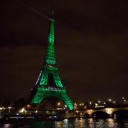Eiffel Tower in Paris illuminated green in celebration of Paris Agreement