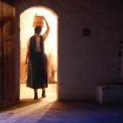 Pueblo woman resting a bucket on her head