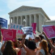 people gathering with signs during a pro-choice rally