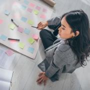 person organizing papers with post-it notes