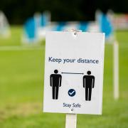 a sign that says keep your distance