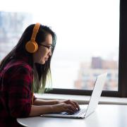 Person sits at laptop computer