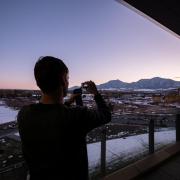 A visitor to the Aerospace Building takes a photo of the view during sunset