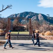 Students walk by Farrand Field, where many of the surrounding oak trees are infested with Allokermes scale