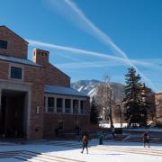 Students walk across a snowy campus