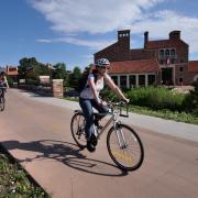 CU employee bikes to work along the creek path