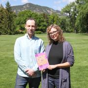 Walker Sampson and Heather Bowden hold their book on the CU Boulder campus